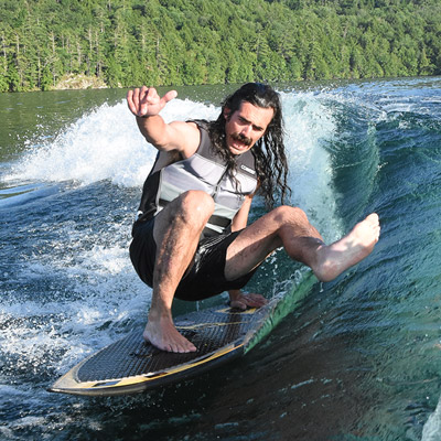 Man on wakeboard behind boat
